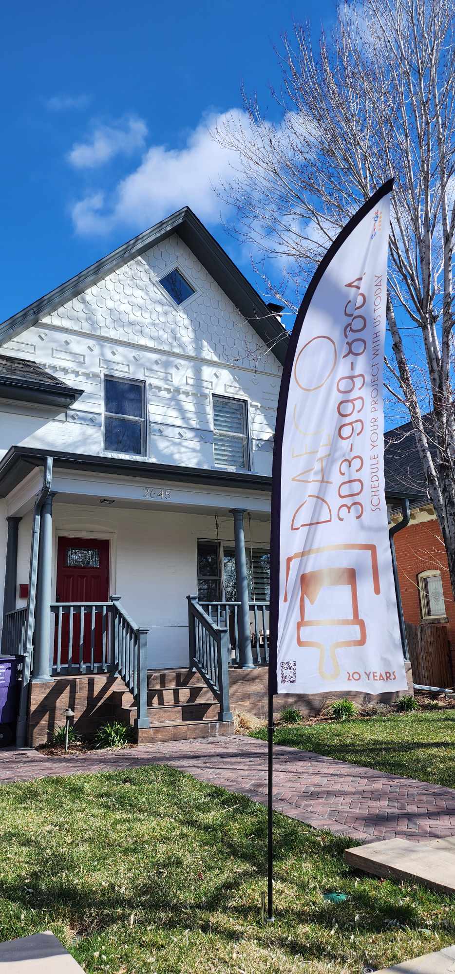 a flag - bearing banner banner flag on a house