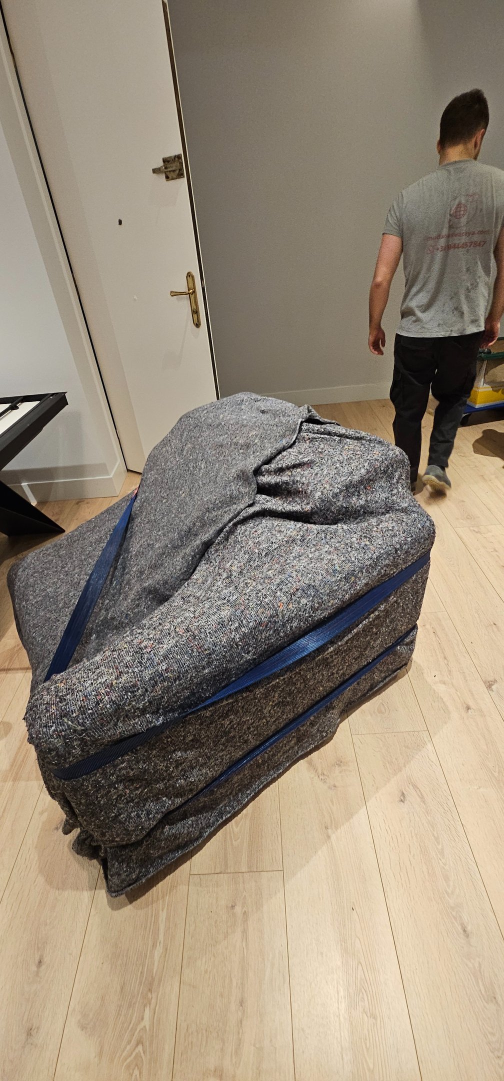 a man walking through a room with a suitcase