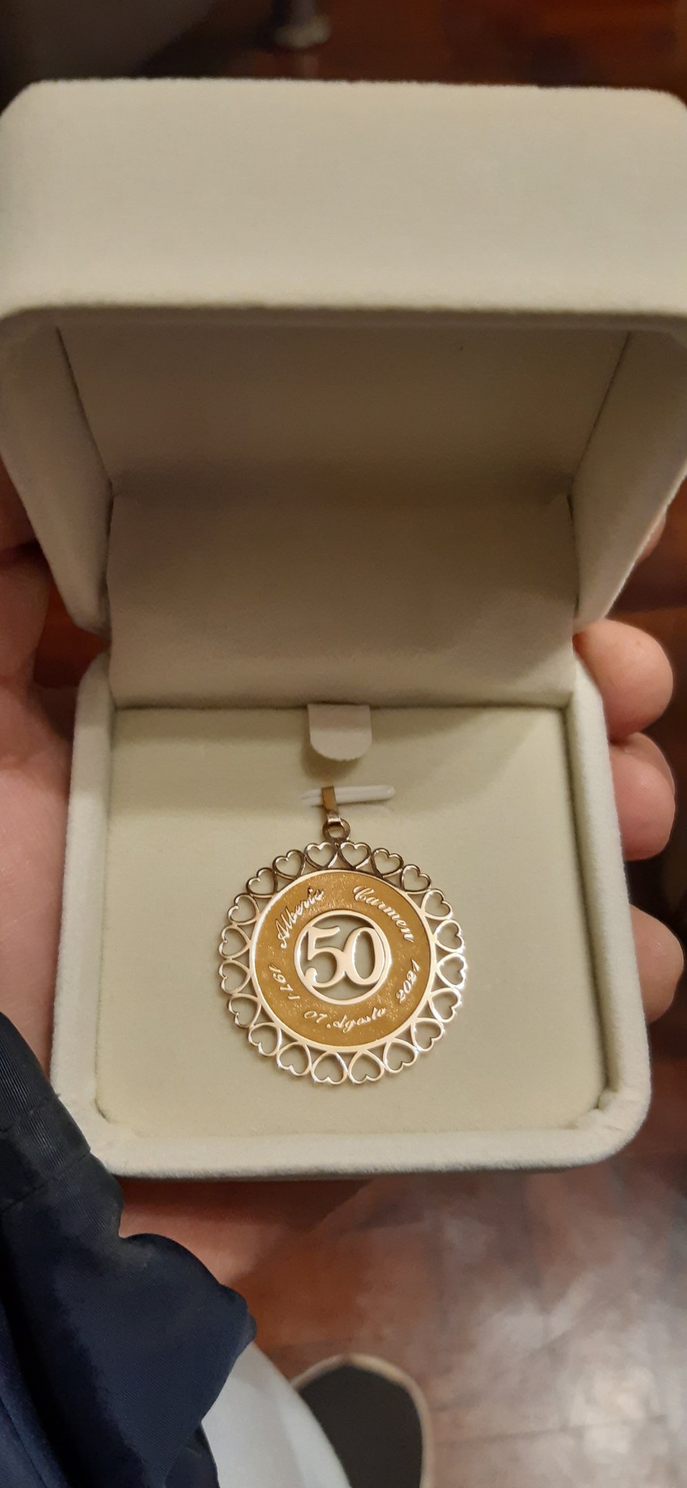 a person holding a medal in a box