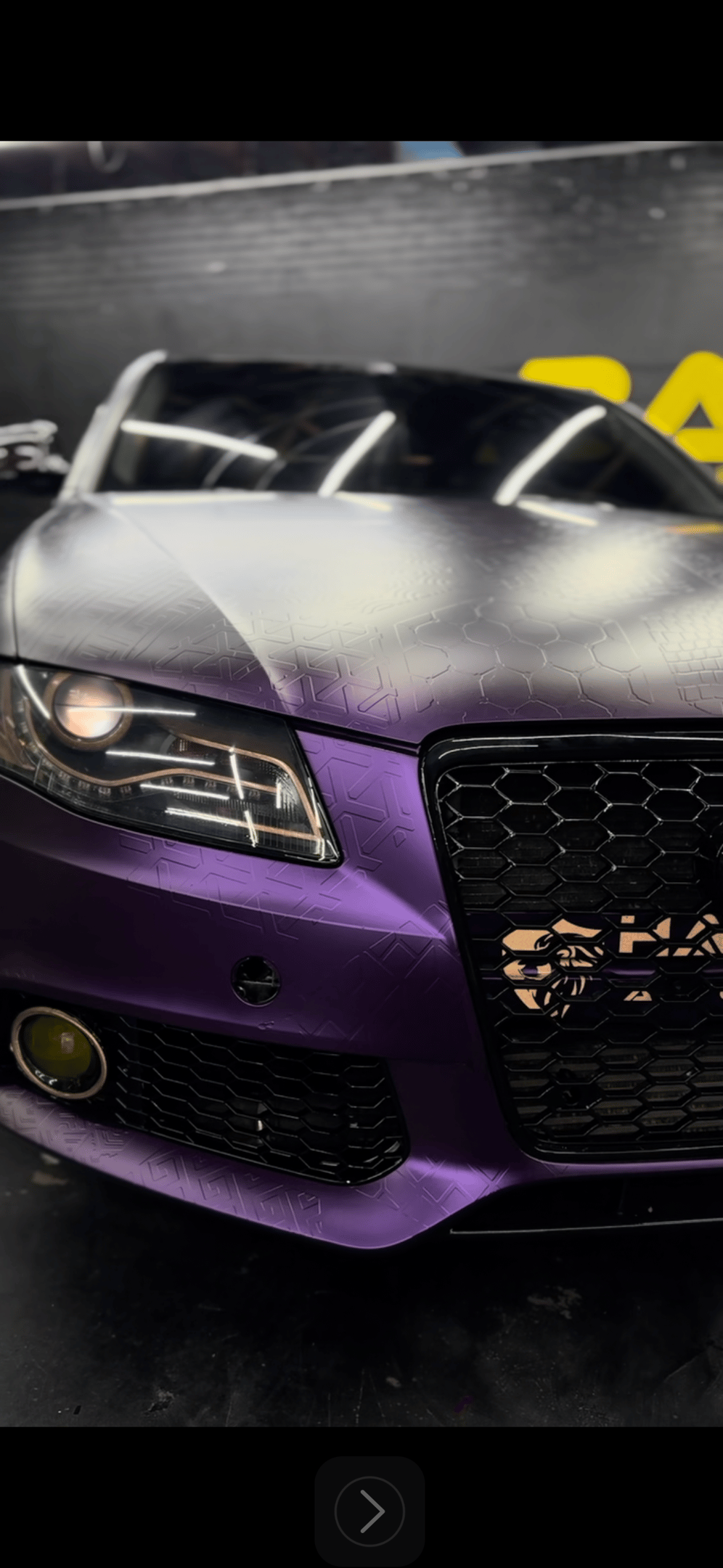 Custom matte purple Audi with a geometric pattern vinyl wrap and honeycomb grille design.