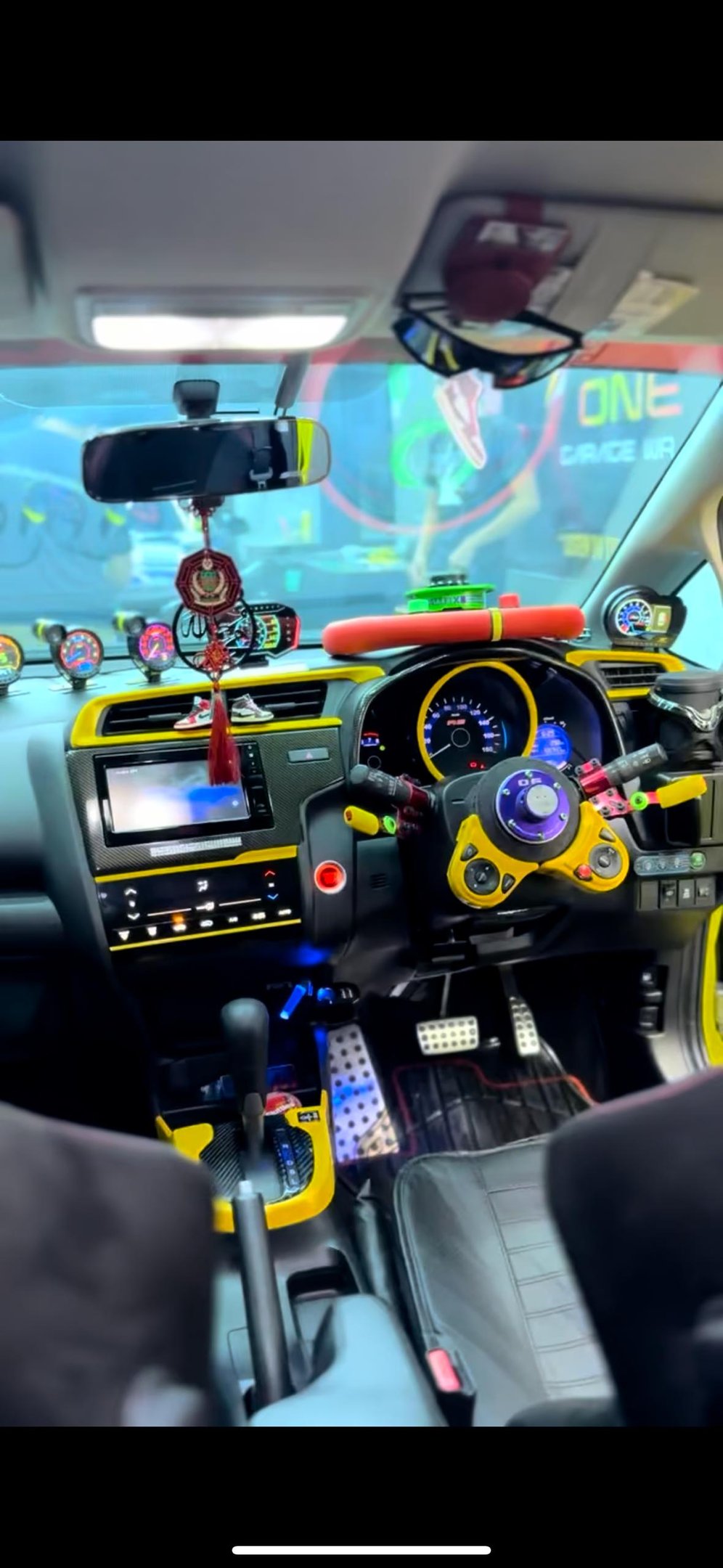 Custom car interior wrap with yellow carbon fiber dashboard trim