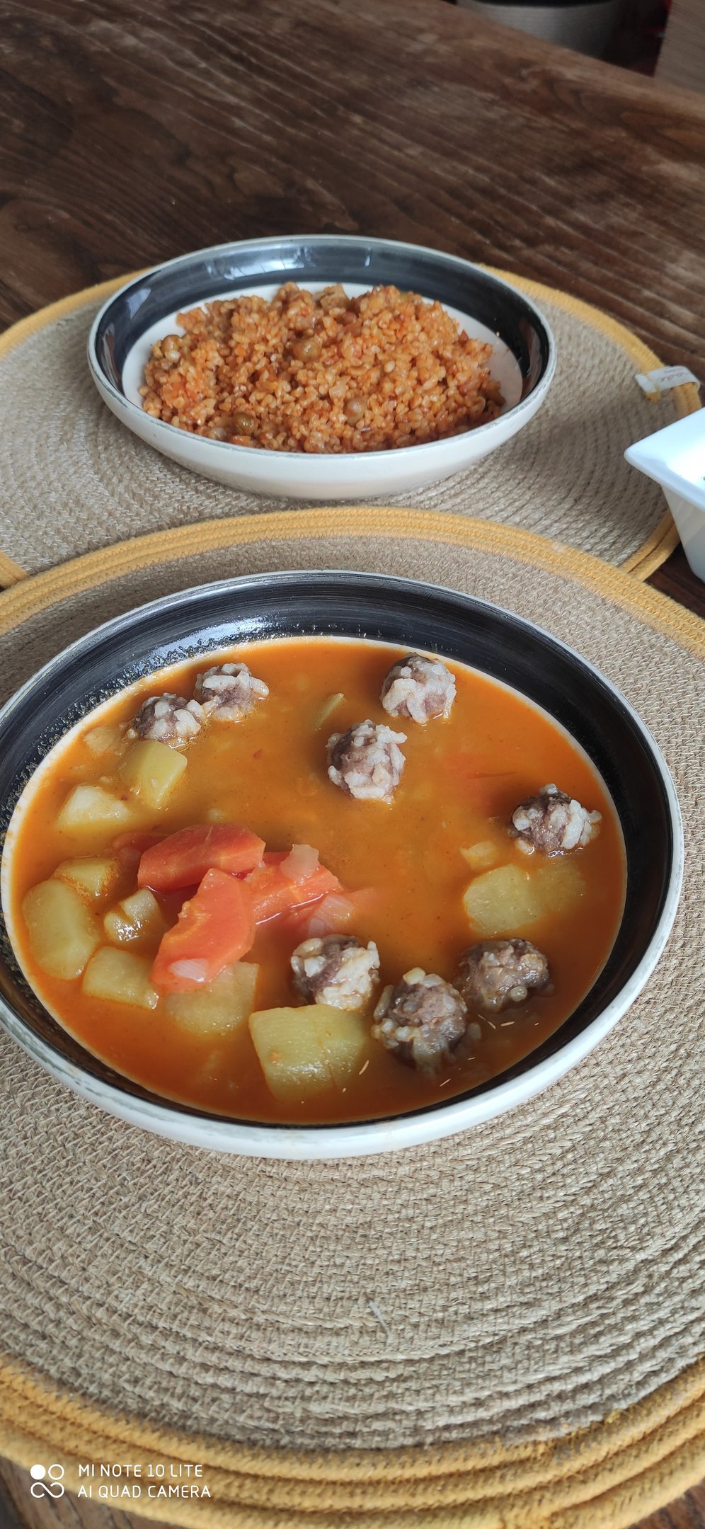 A warm plate of the day's hot meal served alongside fresh olive oil dishes, highlighting the cafe's homemade touch.