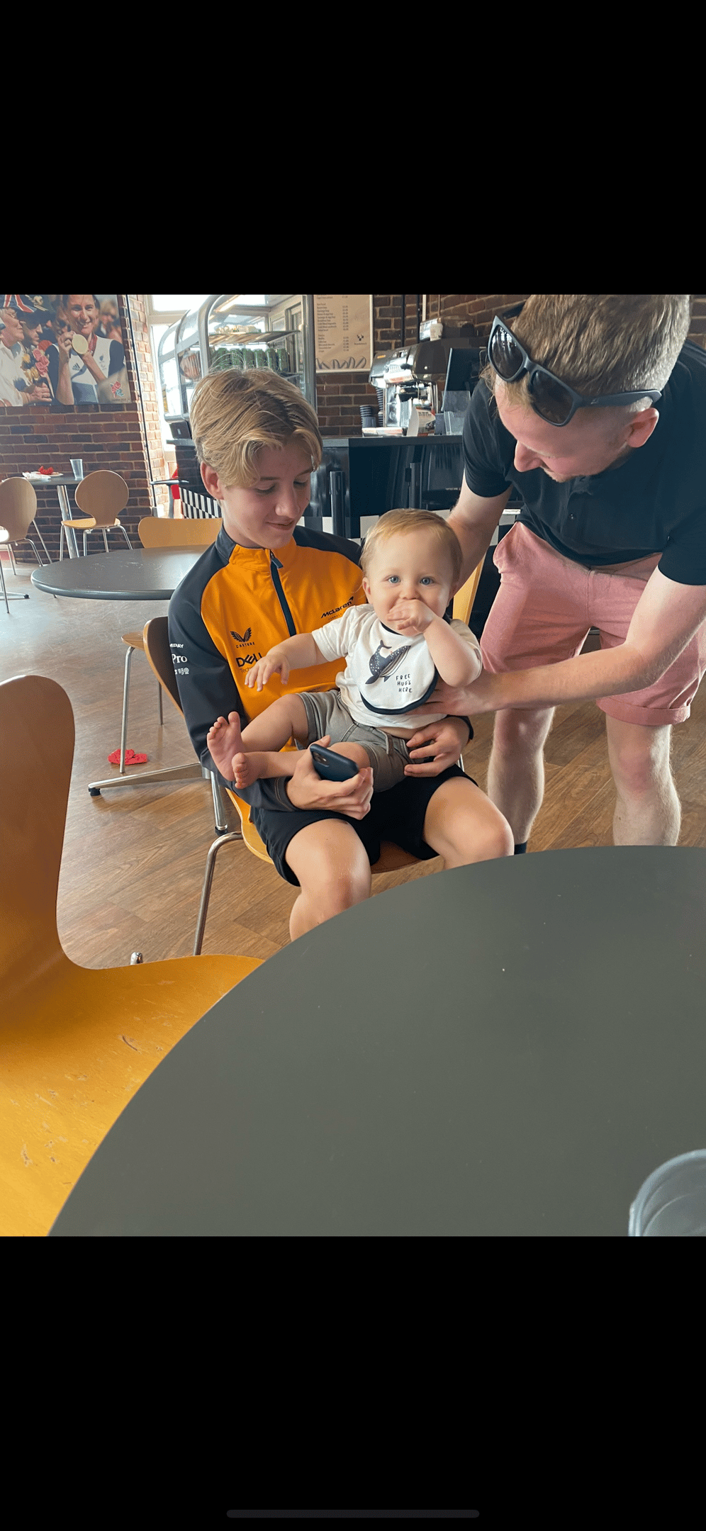 a man and two children sitting in a chair