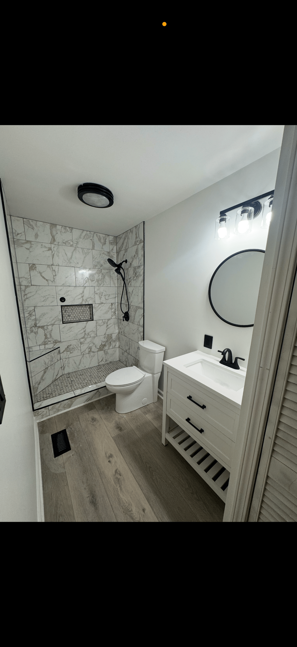 a bathroom with a marble shower and a marble shower
