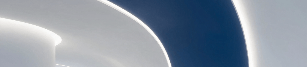 A minimalist, futuristic architectural corridor in a global tech hub. Smooth curved walls with integrated deep blue and soft white LED light strips. High-gloss floors reflecting a sophisticated and clean innovation center. International / Global.