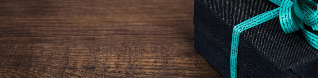 black gift box with a green ribbon