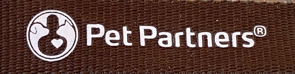 Close up of the Pet Partners brown lanyard, showing the Pet Partners name and logo