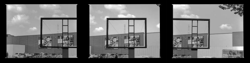 Composed image featuring a spacious vacant outdoor billboard within an commercial urban environment