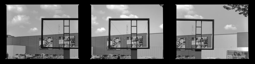 Composed image featuring a spacious vacant outdoor billboard within an commercial urban environment