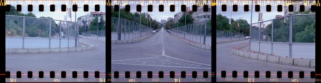 Triptych empty bridge traffic cones lining the right side buildings and trees in the distance