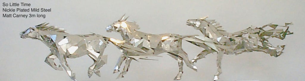 a group of silver horses galloping, with the last becoming pixelated