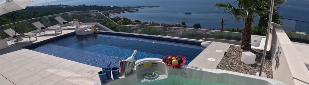 Villa Fay hot tub on pool deck with a view of the ocean