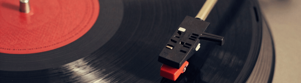A vibrant vinyl record spinning under colorful party lights, capturing the energy of outsider music.