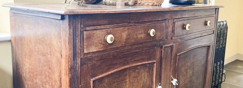 Image of a sideboard that is brown wood and could be painted