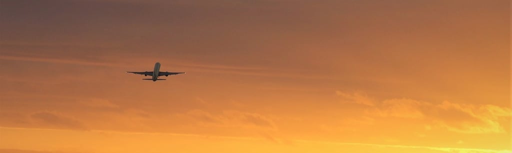 Airliner, airplane takeoff at sunset or sunrise
