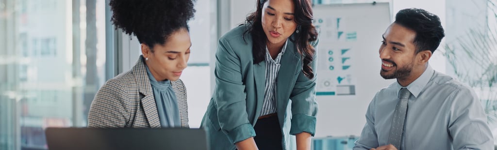 a woman in a business suit is standing in front of a laptop computer