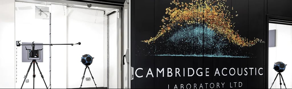 Large logo mural on black background flanked by professional audio equipment in white rooms