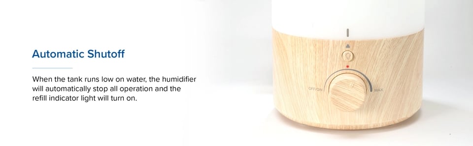 Wood-grain Levoit base close-up with indicator light on and knob pointing toward max