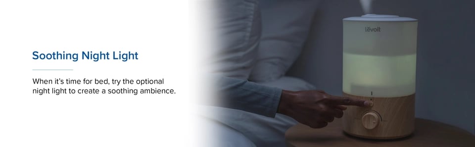 User pressing night light button on softly lit humidifier at bedtime