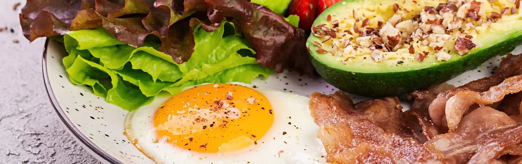 a plate of food with avocado, eggs, bacon, bacon, and