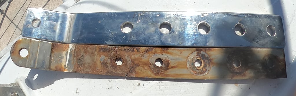 Old rusty chainplate next to new polished stainless steel replacement
