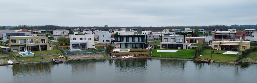 a large body of water with houses in the background
