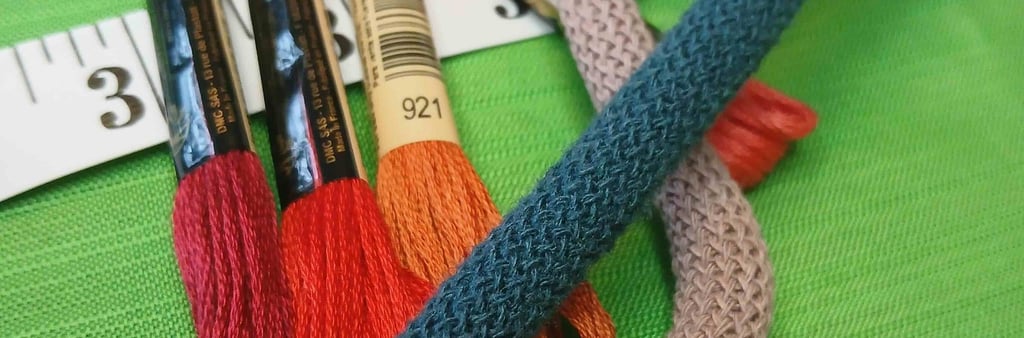 a bunch of thread - wrapped thread threads and scissors