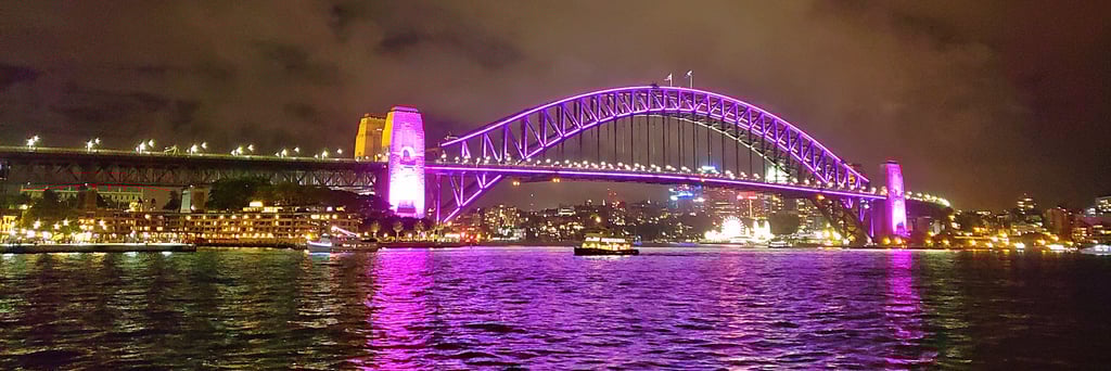The Sydney Harbor Bridge in Australia changes colors at night