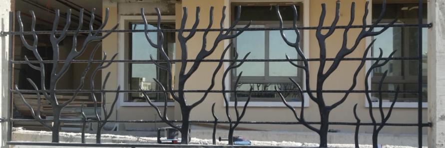 Decorative laser-cut aluminum boundary railing with modern geometric web design.