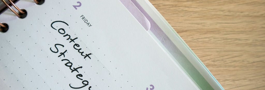 a notebook with a notepad and a pen on a desk