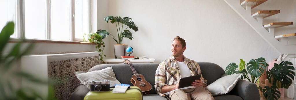 Young British expat working remotely in modern Murcia flat reviewing home insurance policy on tablet