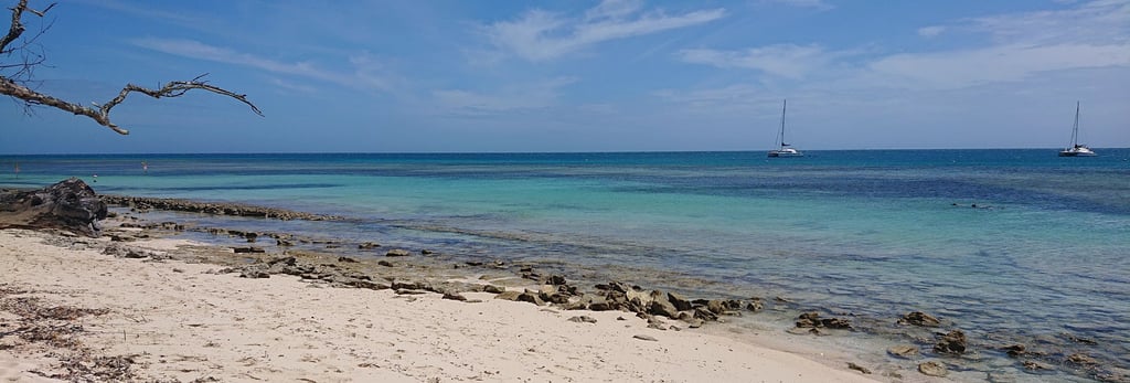 a beach with a boat in the water