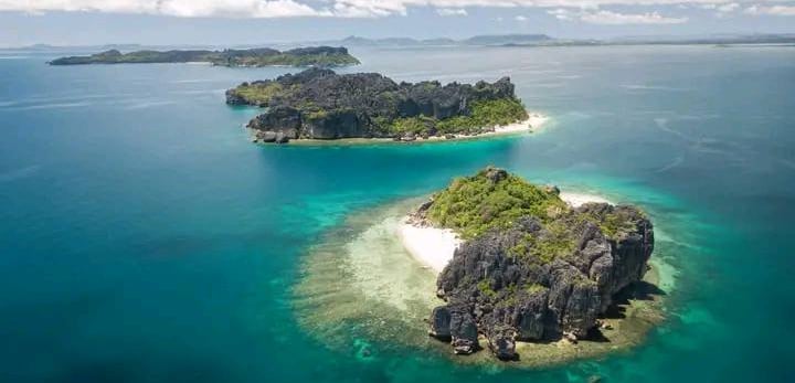 a small island with a small island in the middle of the ocean
