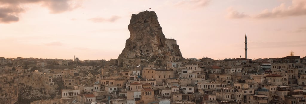 Sunset over Uçhisar Castle and stone village in Cappadocia, Turkey