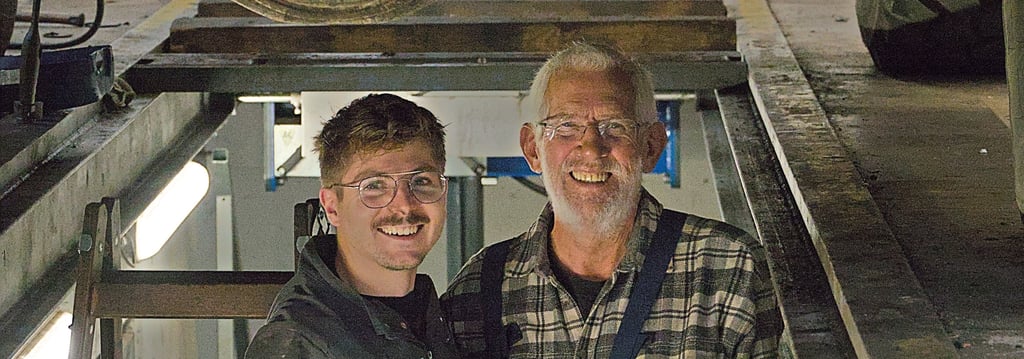 a man and a woman standing in front of a truck