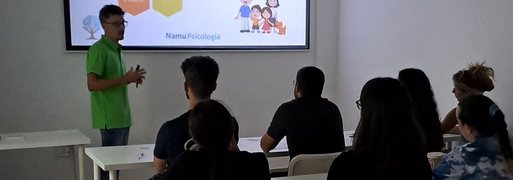 a man standing in front of a classroom with a projector
