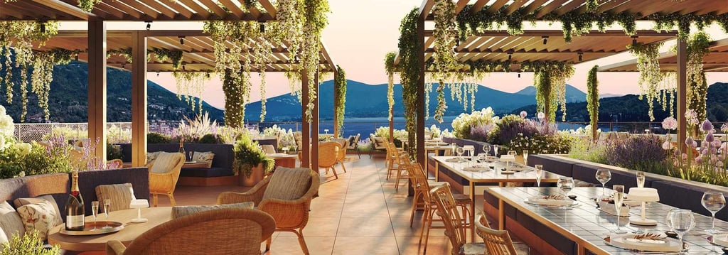 Luxury rooftop restaurant at Hotel Falkensteiner Lake Garda with wooden pergolas, hanging greenery.