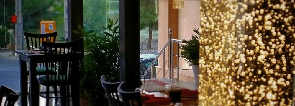 a restaurant with a large window and a table with chairs