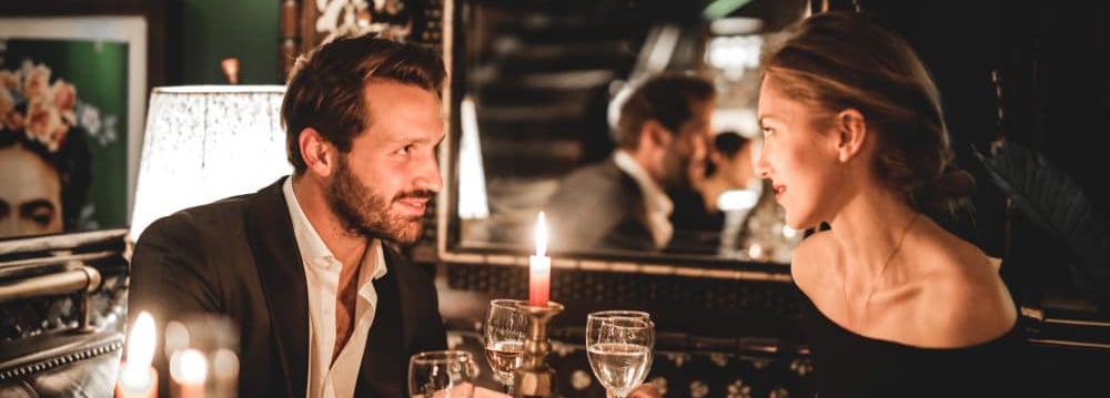 a sugar bay and sugar mommy sitting at a table with candles