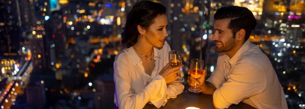 a sugar baby and sugar mommy sitting at a table with candles