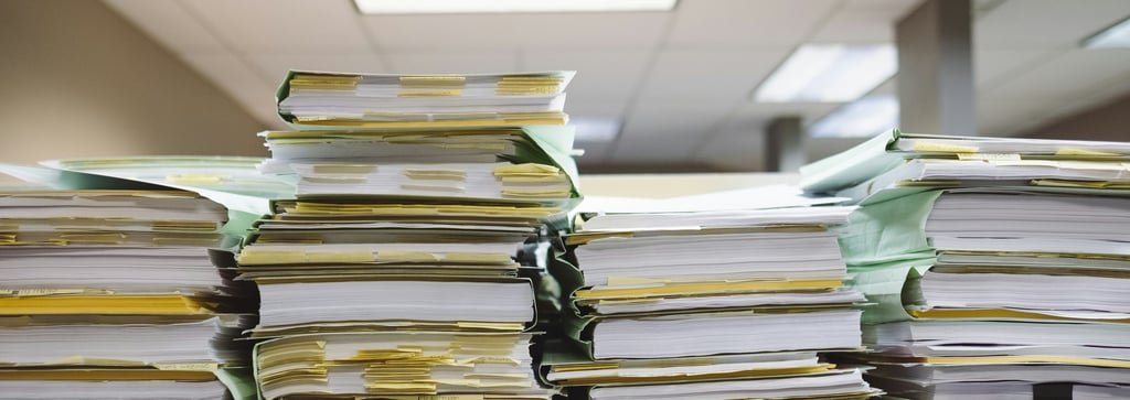 a stack of papers and papers on a desk