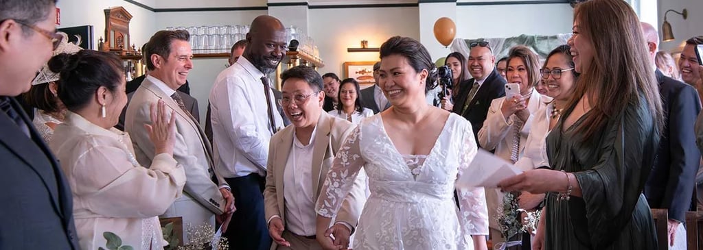 wedding couple walking down the aisle being cheered on by friends and family