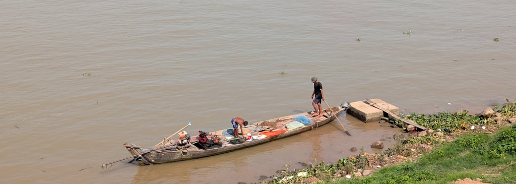a wooden canoe on the banks of the Tonle Sap River in Phnom Penh, Cambodia