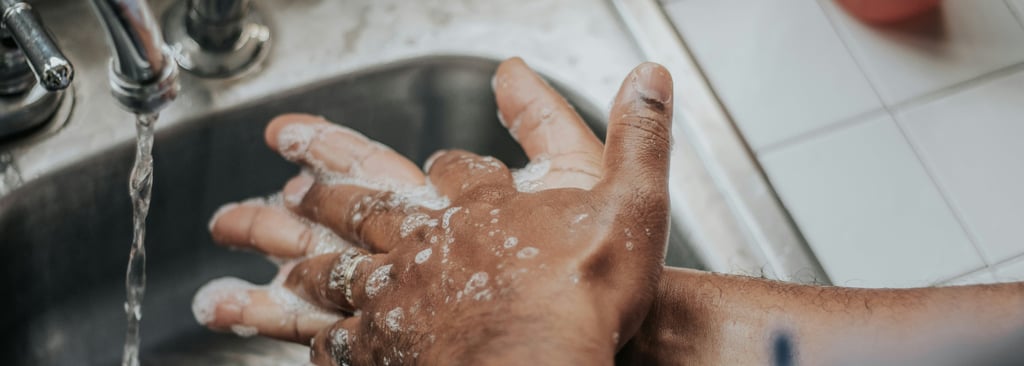 man washing hands with soap