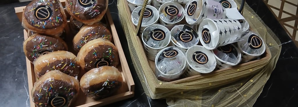 a basket of donuts and coffee cups
