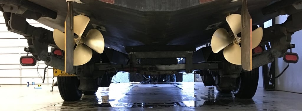 a large boat sitting in a garage props rudders