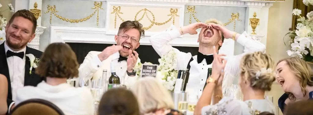 same-sex couple enjoying speeches after their wedding at The Trafalgar Tavern Greenwich
