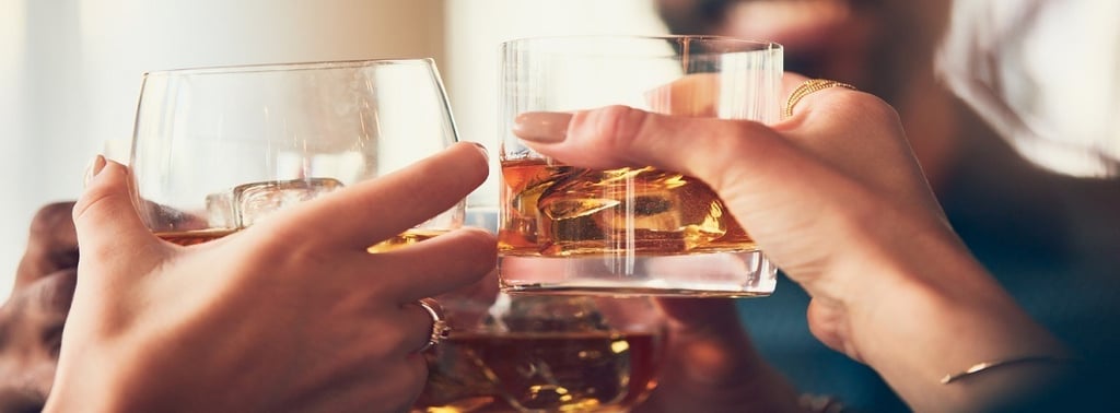 People holding alcohol in the glass