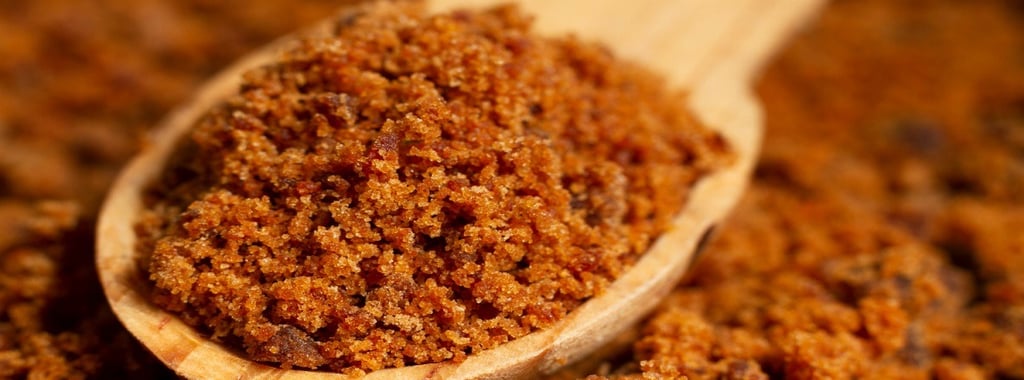 Jaggery on a wooden spatula