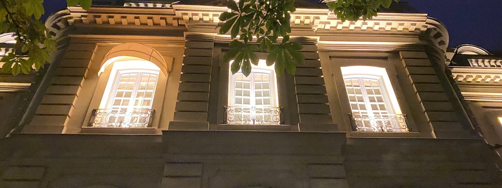 Santo Mauro Hotel, a building with 3 windows lighting in the middle of the night